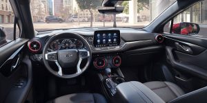 Interior view of a Chevrolet vehicle showing steering wheel, dashboard, and infotainment screen