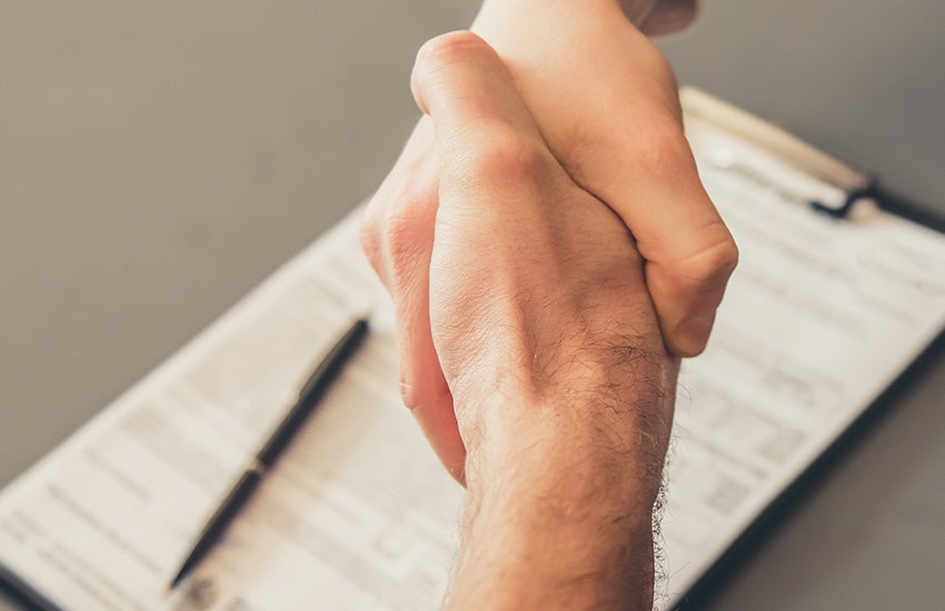 Close-up of a person holding their wrist, suggesting wrist pain or discomfort.
