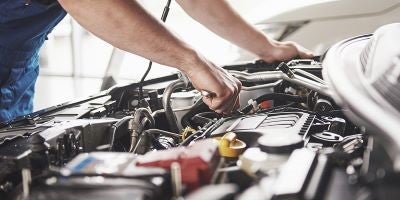 Mechanic inspecting a car engine.